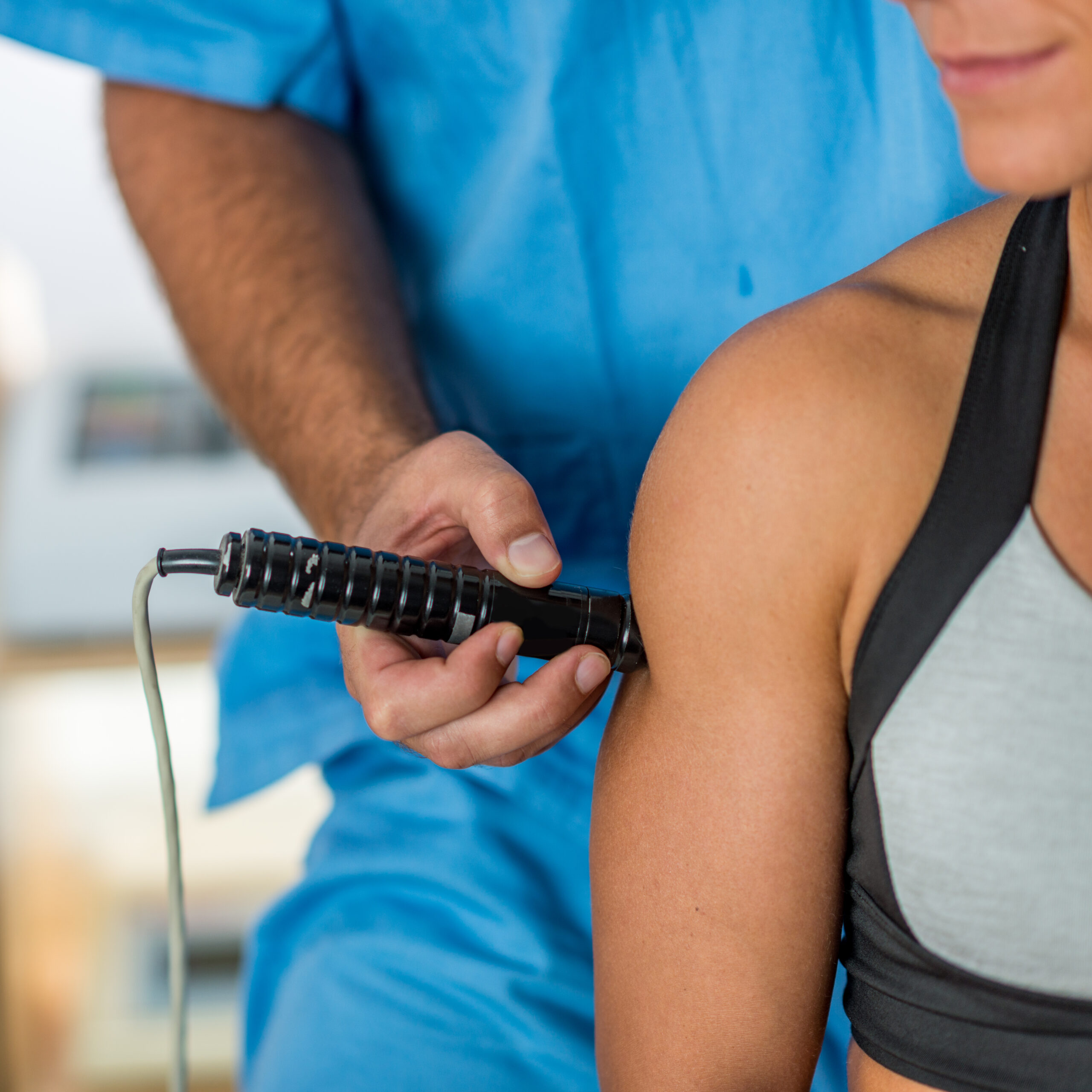 Laser therapy. Physical therapist treating patient's arm muscles